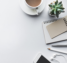 . Image - White desktop with coffee, cactus, note pads, pen, pencil, headphones and phone. Click tile image to view